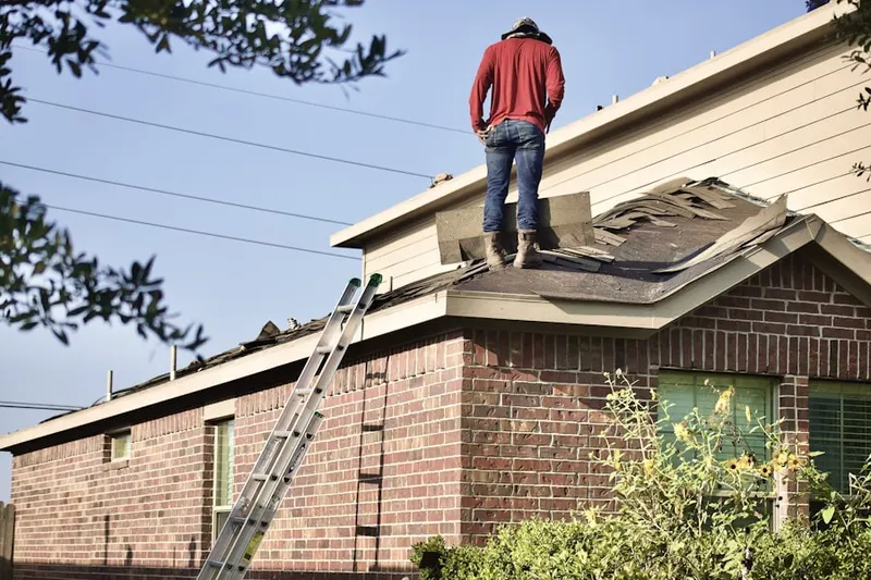 Professional roofer working on a residential roof in Downtown Ontario